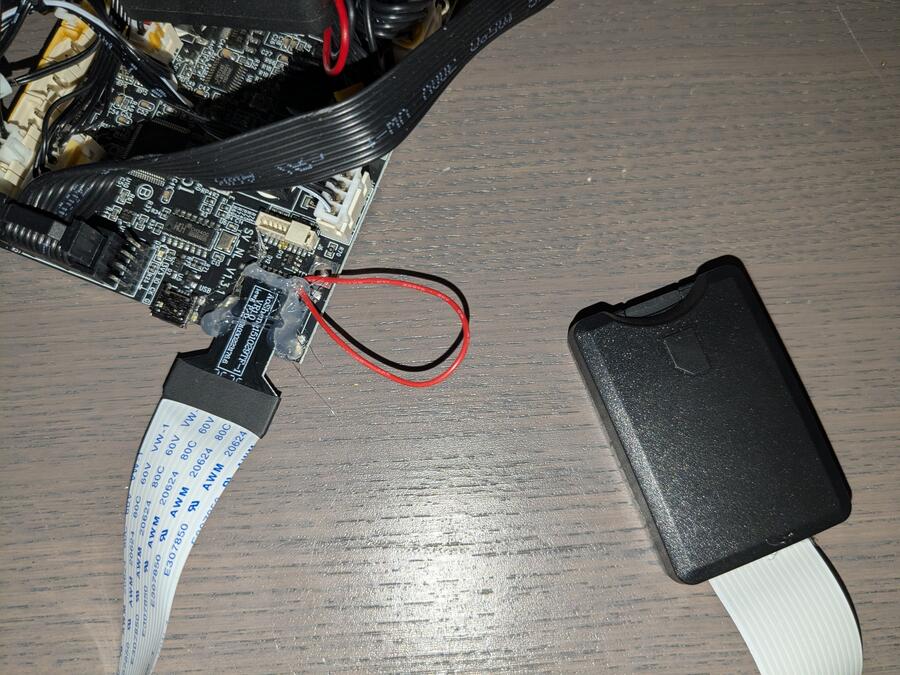 The extension cable with jumper wire hot glued into the exposed port.