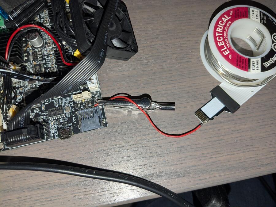 A jumper wire soldered from the pad of the broken pin to the matching contact of the SD extension cable.